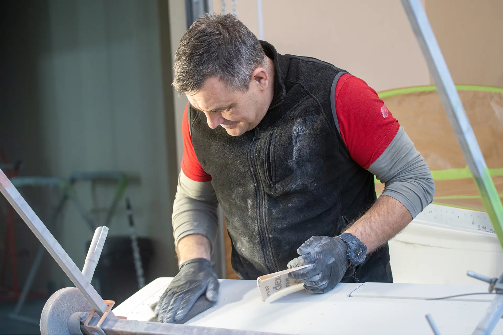 Craftsman hand-finishing a Belmont aircraft surface during the painting process