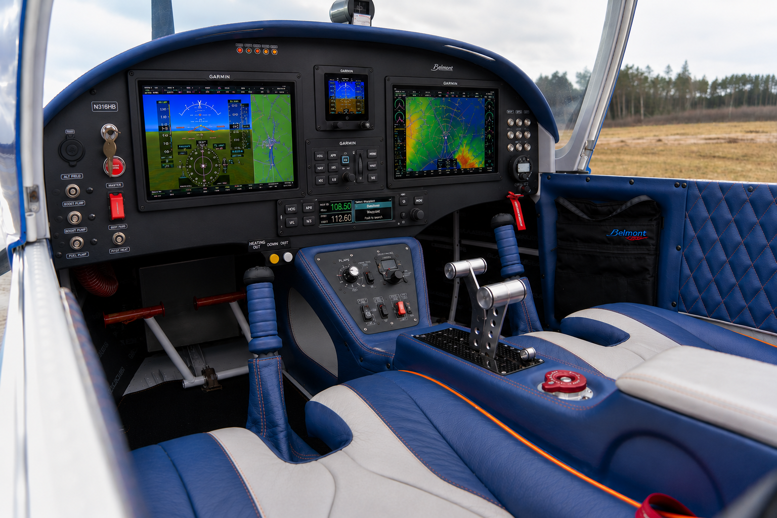 Belmont cockpit with Garmin avionics, dual screens, and blue diamond-quilted leather interior