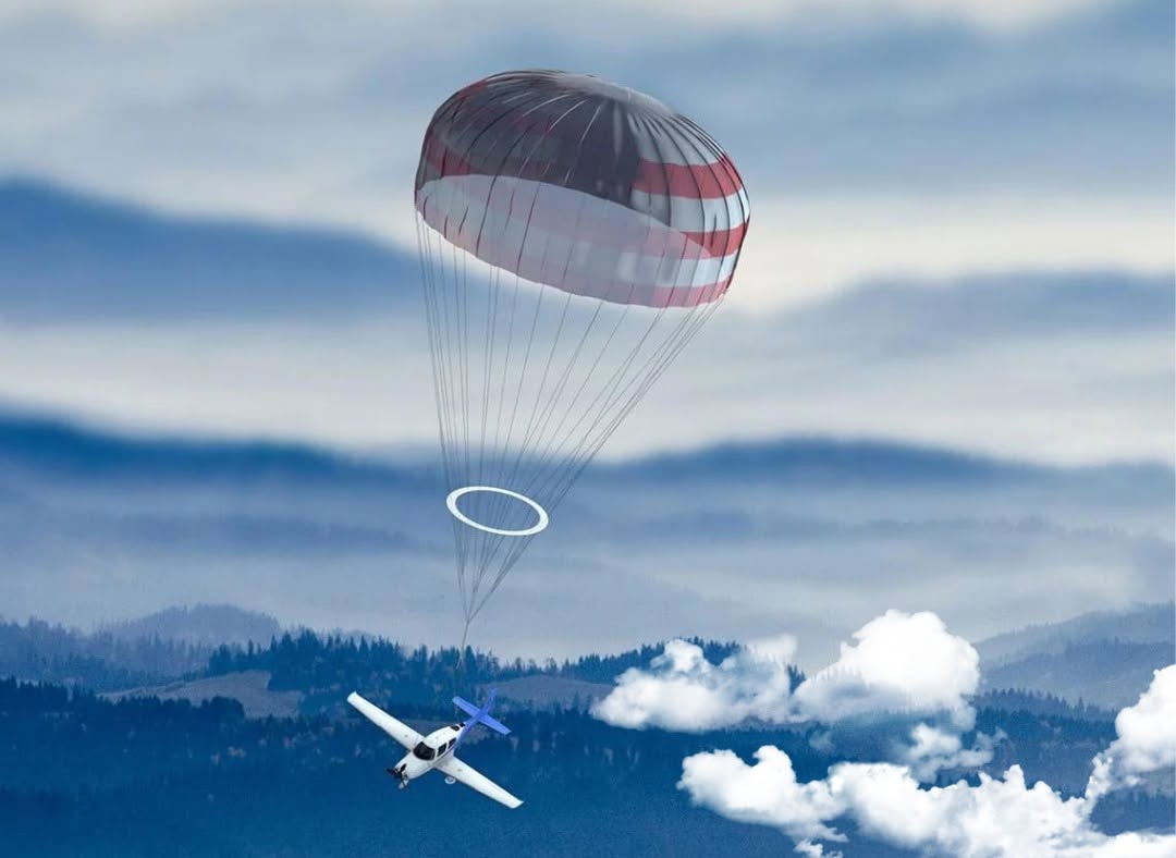 Light aircraft descending under a deployed whole-airframe ballistic recovery parachute over mountains
